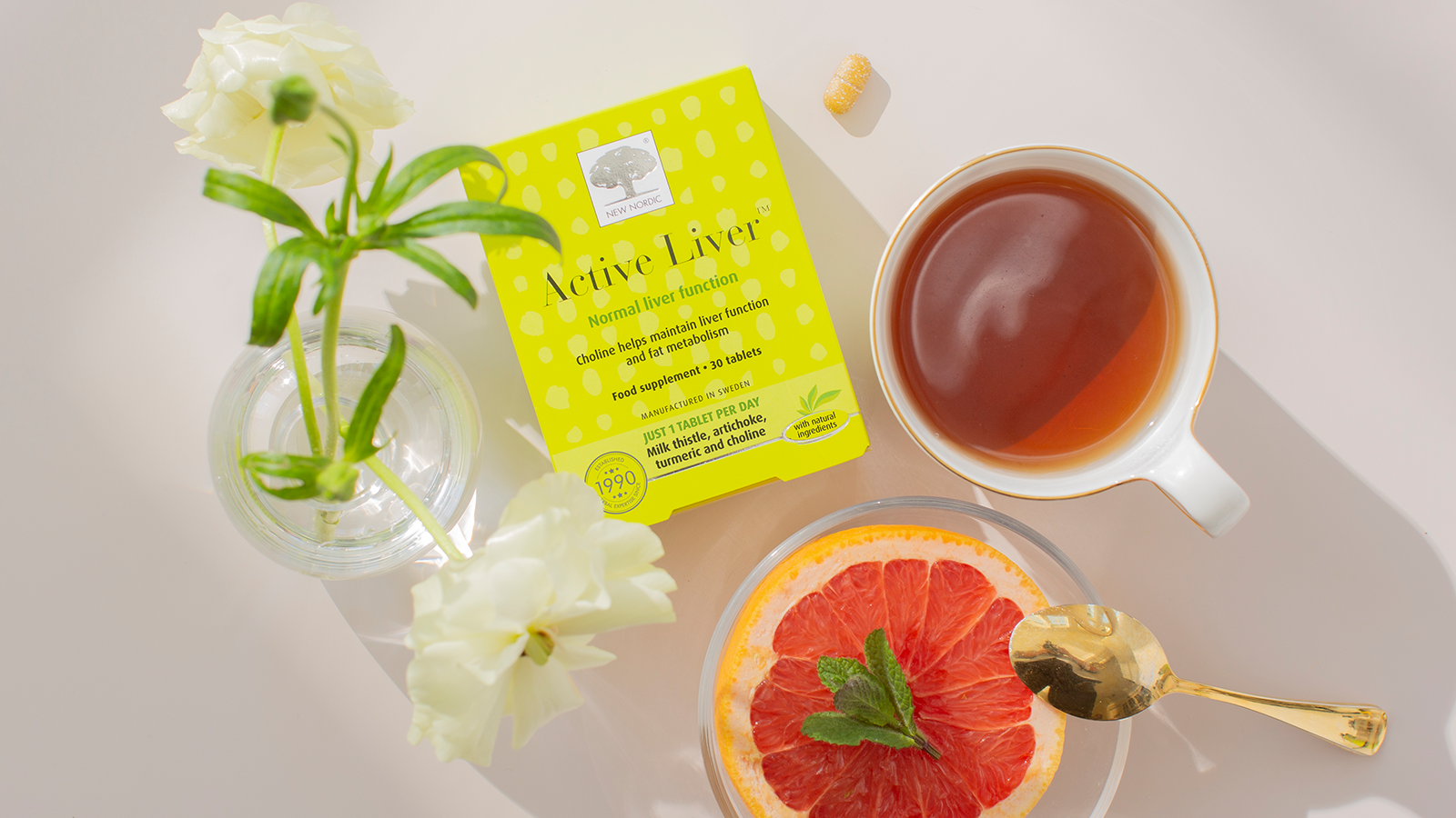 Our Sustainability Mission 11 New Nordic Active Liver™ package displayed alongside some tablet ingredients on a light background