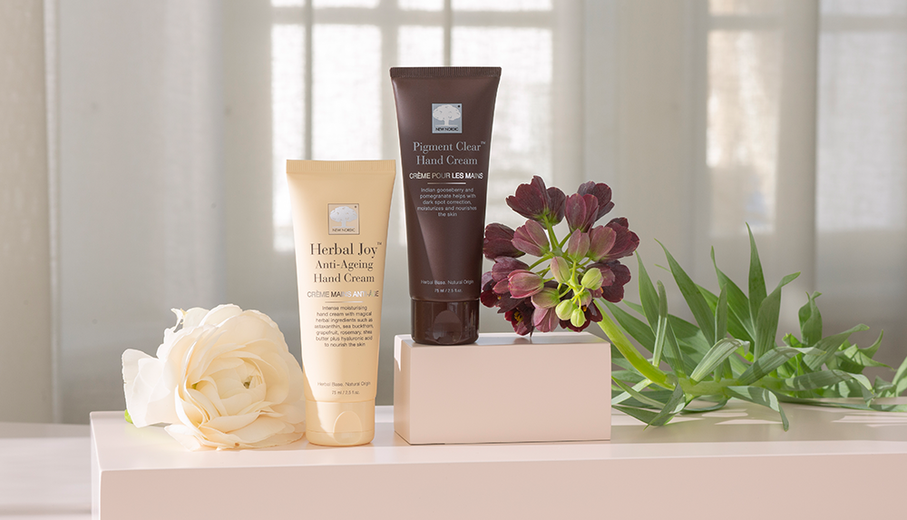 a group of hand creams and flowers