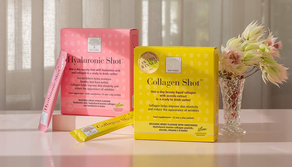 Our supplement shots on a table with flowes