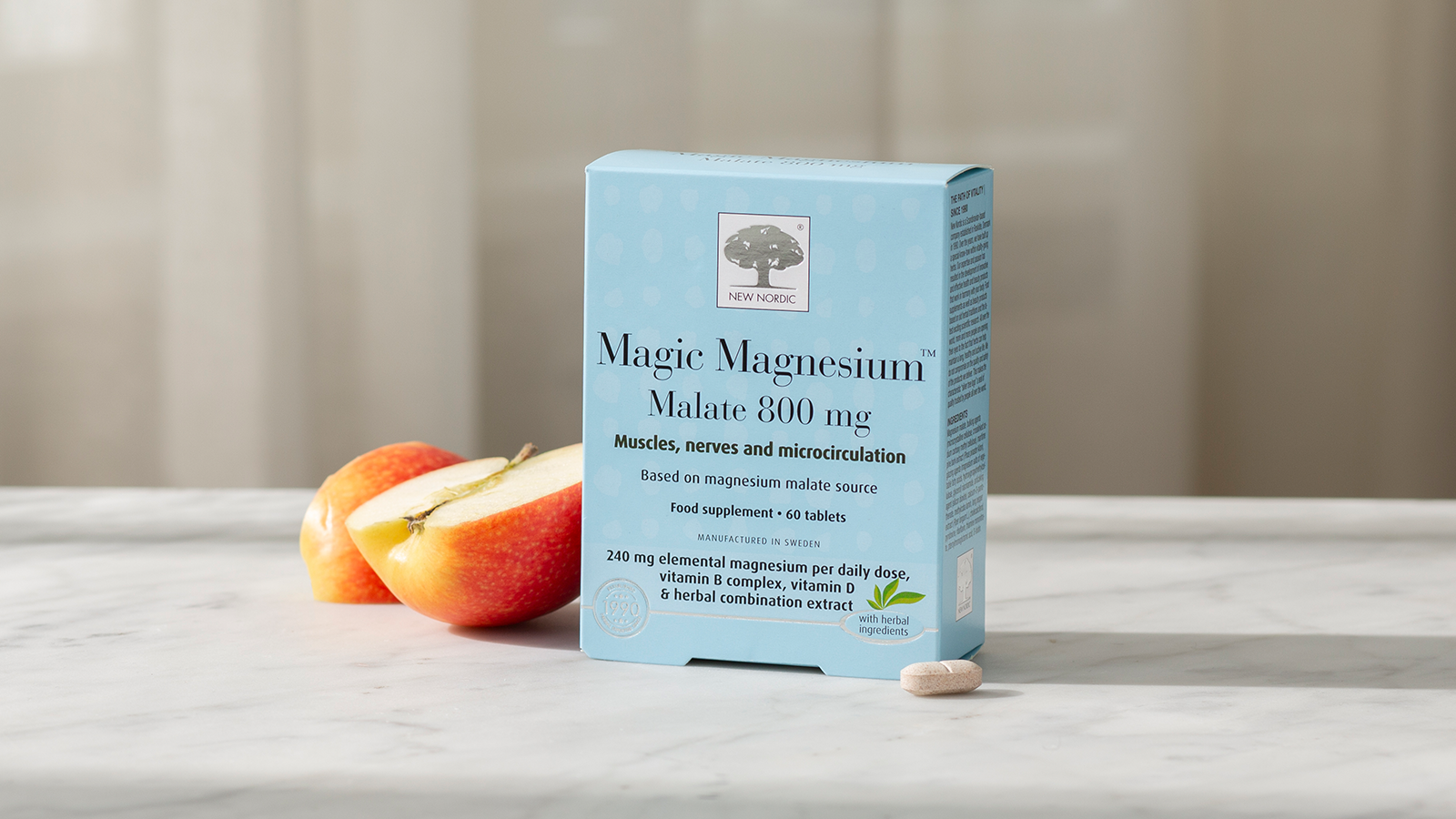 Transparent Testing 10 Magic Magnesium™ Malate with apples and a tablet on a light background.