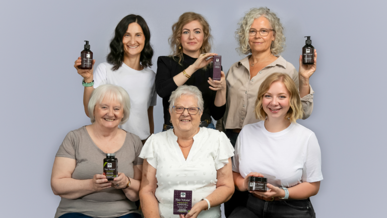 Hair Volume⢠Shine Serum 10 Six women smiling and holding products from the New Nordic Hair Volume⢠Series