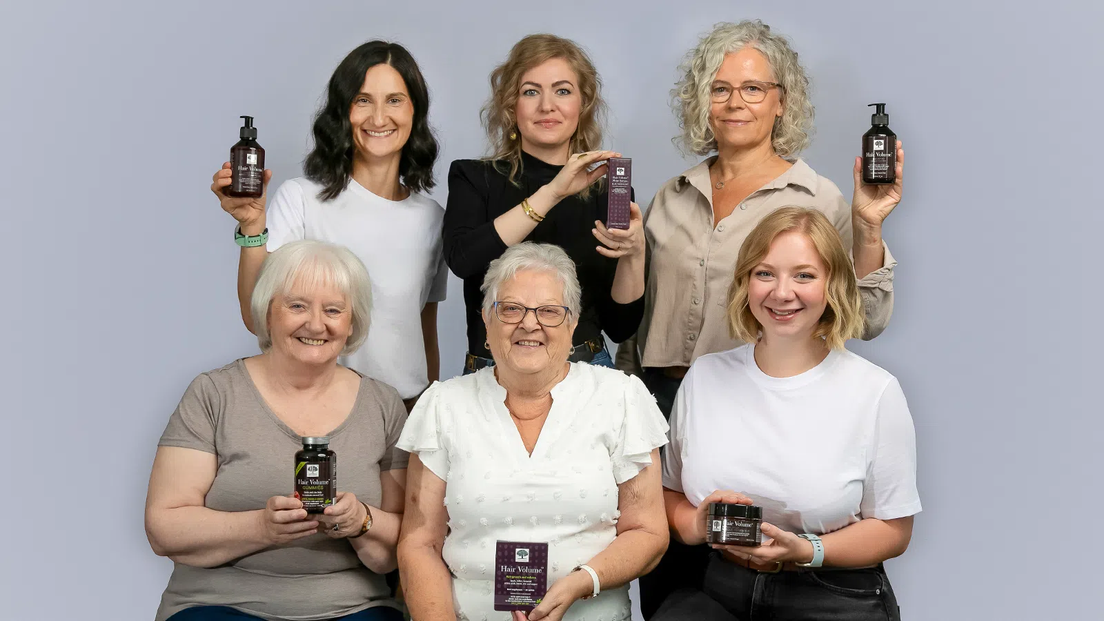 Home 25 Six women smiling and holding products from the New Nordic Hair Volume™ Series