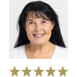 Natural Magic™ Anti-ageing Cream 12 Woman smiling with five stars displayed underneath.