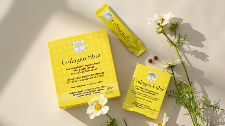 Natural Magic⢠Intense Marine Mask 12 Collagen Shot⢠and Collagen Filler⢠surrounded by flowers.